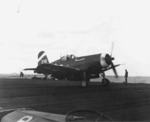 Tailhook of an F4U Corsair from Fighting Squadron VBF-6 hooking an arresting cable aboard USS Hancock off Okinawa, Japan, 21 Mar 1945. Note aircraft tractor tug in the foreground.