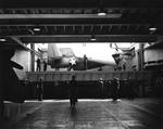 A TBM Avenger on an aircraft carrier elevator as seen from the hangar deck, 1943