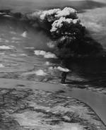 Strike photo from USS Yorktown (Essex-class) aircraft showing burning oil storage tanks on the banks of the Mekong River in Saigon, French Indochina (Ho Chi Minh City, Vietnam), 12 Jan 1945.