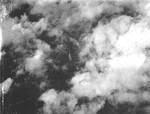 Photo through the cloud cover taken from aircraft from Bombing Squadron VB-14 from the USS Wasp (Essex-class) showing the discovery of a Japanese warship underway, 1944