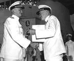 Fleet Admiral Chester Nimitz presenting Admiral William Halsey with a gold star in lieu of a fourth award of the Navy Distinguished Service Medal aboard USS Missouri in Pearl Harbor, 28 Sep 1945.