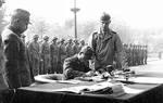 Lieutenant General Ginnosuke Uchida surrendering his forces to the Chinese, former French Concession zone, Tianjin, China, 7 Oct 1945; the surrender document was accepted by USMC Major General Keller Rockey on behalf of the Chinese