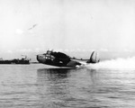 US Navy PBM Mariner using Rocket Assisted Take-Off packs (RATO) at Port Lyautey, French Morocco, 1945. Note OS2U Kingfisher float planes on the fantail of a battleship at left.