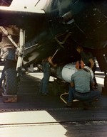 Aviation Ordinancemen loading a Mark XIII torpedo into the bomb bay of a TBM Avenger aboard USS Bennington, May 1945. Note the torpedo’s plywood drag ring on the nose and wooden tail shroud.