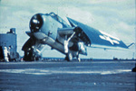 TBM-3 Avenger folding its wings after landing on an aircraft carrier in the Pacific, 1944-45. Poor quality photo but shows well the three-color paint scheme used on United States Navy aircraft in the Pacific.