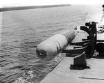 A Mark XIII aerial torpedo being launched from a PT Boat by simply dropping it over the side during tests in the Rendova area of the Solomon Islands, 1943.