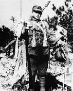 Chinese soldier displaying captured Japanese equipment, Tai