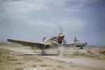 Kittyhawk Mark III fighter with the RAF 112 Squadron taxiing at Medenine, Tunisia, May 1943. The crewman on the wing is helping guide the pilot whose view is obscured by the aircraft’s raised nose.
