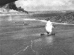 Japanese freighter at Truk, Caroline Islands hit by a torpedo dropped from a US Navy squadron VT-10 Avenger aircraft, 17 Feb 1944, photo 2 of 2