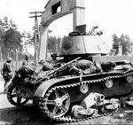 A destroyed T-26 tank surrounded by dead Red Army soldiers near the German-Soviet border in occupied Poland, late Jun 1941