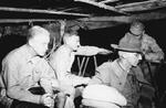 Brigadier General William Bergin, Brigadier General Hayden Boatner, Lieutenant General Joseph Stilwell resting with cups of cocoa while watching a movie at Shadazup, Burma, 21 Jul 1944