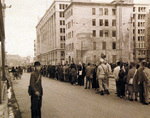 Civilians and two USS Chenango crewmen lining up for trolley, Ginza Street, Sasebo, Japan, Sep 1945