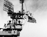 V-J flag and US flag being flown from USS Chenango while at Sasebo, Japan, Sep-Oct 1945