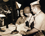 Captain E. Grant and Lieutenant Rogers of USS Cumberland Sound consulting with a Japanese Navy pilot on the navigation of Tokyo Bay, Japan, 28 Aug 1945