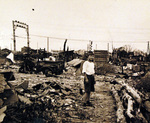 Japanese boy among the ruins of a Japanese city, Sep 1945