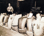 US Navy Chaplain Lieutenant Sam H. Franklin conducting English lessons for Japanese prisoners of war, Guam, Aug-Sep 1945