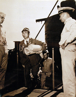 A Japanese naval officer with charts of Sagami and Tokyo Bays arrived aboard USS Missouri for a conference with Admiral William Halsey