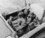 MGen George Patton and RAdm John Hall, US Navy (behind Patton – and, Yes, the Admiral has his helmet on backwards) prepare to go ashore at Fedhala, Morocco during the North African operation, 9 Nov 1942.
