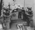 The helm of PT-295, a Higgins 78-foot motor torpedo boat, 1944. Note the mast in the lowered position, two twin Browning .50 caliber machine gun mounts, and a 20mm Oerlikon gun forward.