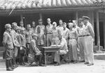 Colonel Louis P. Ely reading surrender terms of Major General Toshio Taga, Okinawa, Japan, 5 Sep 1945