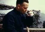 Milton Miles drinking tea while working, Chongqing, China, 1944