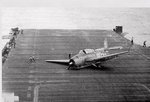 TBM-1C Avenger crash landed aboard USS Hornet (Essex-class) after the landing gear collapsed due to hydraulic failure from battle damage, 15 Jun 1944. Photo 1 of 2.