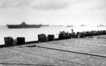 As seen from of the USS Hancock, the USS Lexington and USS Yorktown (both Essex-class) are anchored close aboard at Ulithi, late Dec 1944. Note Hancock’s 20mm anti-aircraft guns lining the flight deck.