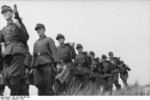 German MG 42 machine gun crews marching along the French coast, 1944