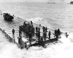 Good view of a Rhino barge as crews drill in English waters prior to the Normandy invasion, May 1944. Rhino barges were an assembly of 180 welded 5x7x5 foot steel boxes powered by 2 outboard motors of 143 hp each.