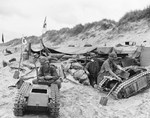 Members of the US Navy’s Second Beach Battalion disassembling two German SdKfz 302 Goliath remote-controlled mines (called Beetles by US forces) on Utah Beach, 11 June 1944.