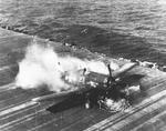 Ensign Ardon R. Ives of Fighting-Bombing Squadron VBF-9 crashed his F6F-5 Hellcat through the barrier on USS Lexington (Essex-class) and ruptured the center-line fuel tank, Feb 1945, western Pacific. Photo 1 of 7
