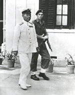 Japanese Navy Vice Admiral Ruitaro Fujita arriving at Government House, Hong Kong, for the surrender ceremonies while escorted by a Royal Marine, 16 Sep 1945. Note Thompson M1A1.