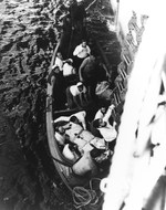Captured German crewmen from U-505 climbing a Jacob’s ladder from a whaleboat to come aboard USS Guadalcanal (CVE-60), after their rescue from the Atlantic, 4 Jun 1944.