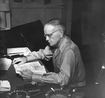 Admiral William Halsey at his desk aboard his flagship, USS New Jersey, on his way to operations against the Philippines, Dec 1944