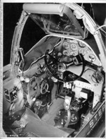 Close-up view of a P-38G Lightning aircraft cockpit, 23 Dec 1942; note the yoke rather than stick control and the bullet proof glass panel above the instrument panel. Photo 3 of 3.