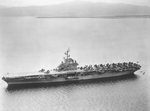 USS Randolph at anchor in Guantanamo Bay, Cuba, fall 1953. Note that the twin 5-inch gun turrets have been removed from the flight deck and also note F9F Cougar jet aircraft forward with wings folded.