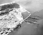 Supply ship SS Nira Luckenbach, submarine tenders Bushnell and Sperry, and submarines Sunfish, Haddock, Tarpon, Seahorse, and Swordfish at the submarine base piers on Sand Island, Midway Atoll, 29 Sep 1943.