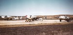 Three PV-1 Ventura patrol planes preparing for take-off from Port Lyautey, French Morocco (now Kenitra, Morocco), May 1945. Note plane director with a red flag standing on the hood of the yellow Jeep