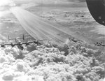 B-24 Liberators of the 451st Bomb Group flying from Castelluccio, Italy (Foggia complex) leaving condensation trails during a mission, 1944-45.