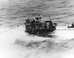 A salvage party from USS Guadalcanal on the captured German submarine U-505, 4 Jun 1944 in the eastern Atlantic. Note the twin 20mm anti-aircraft guns and the seashell insignia on the tower.