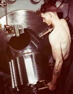 Fire Controlman First Class E.M. Smith, gun captain of one of the USS Missouri’s nine 16-inch main guns, opens the gun’s highly polished breech plug during the ship’s shakedown cruise to Trinidad, Aug 1944.