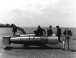 Mark XIII torpedoes on the deck edge elevator of USS Bennington ready for loading onto TBM Avenger torpedo bombers, off Okinawa, March 1945. Note wooden drag rings on the noses and stabilizers fitted to tails.