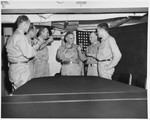 Aboard his flagship, USS Missouri, Adm William Halsey toasts Japan’s surrender with RAdm Robert Carney, Royal Navy Capt JPL Reid, Royal Navy VAdm Sir Bernard Rawlings, VAdm John McCain, and RAdm Wilder Baker, 22 Aug 1945