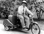 US Navy photographer Tai Sing Loo was well known around the Navy yard with his trademark pith helmet and his bright red, gasoline powered, three-wheeled “putt-putt”, Pearl Harbor, Hawaii, 1940s.