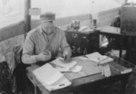 Chuck Hytla of US 5332nd Brigade (Provisional) working at a desk in the field, probably Burma, 1945