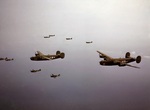 P-40 Warhawk fighters of the 18th Fighter Squadron escorting B-24 Liberator bombers of the 21st Bomb Squadron over the Aleutian Islands, Alaska, Jul 1943.