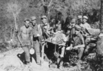Members of US 5332nd Brigade (Provisional) having a meal in the field, Burma, 1945; T. Smith, Thompson, Rappert, Horton, R. Smith, Winters, Knight, J. W. Simpson, J. R. Simpson, and Strubel