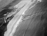 United States Army troops making their initial landing at Safi, Morocco south of Casablanca, 8 Nov 1942. Photo taken from an airplane flying from the USS Santee.