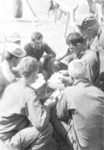 Bartello of US 5332nd Brigade (Provisional) passing out mail to Mahl, Routson, Rokita, Frederick, and two others, Burma, 1945