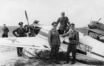 Germans inspecting captured UT-1 aircraft (foreground) and wrecked I-16 aircraft (background), 1941